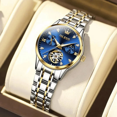 Montre femme OLEVS Charlotte bleue posée sur un coussin