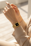 Montre OLEVS Sophie noire portée au poignet avec bracelet doré